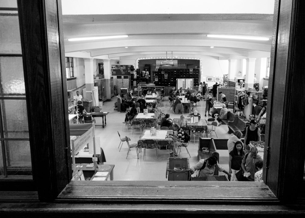 Community members share a meal together in the basement of Trinity Church during one of The Depot's early community meals.