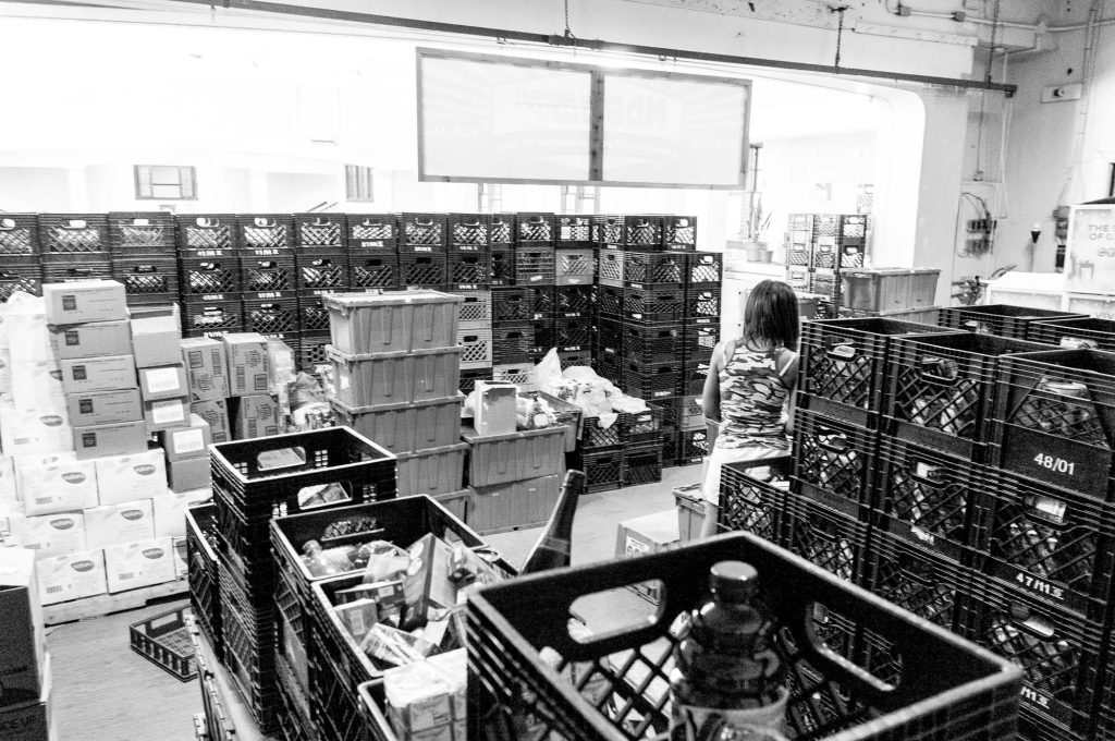 Milk crates filled with donated processed food items at The Depot's former location in the basement of Trinity Church.
