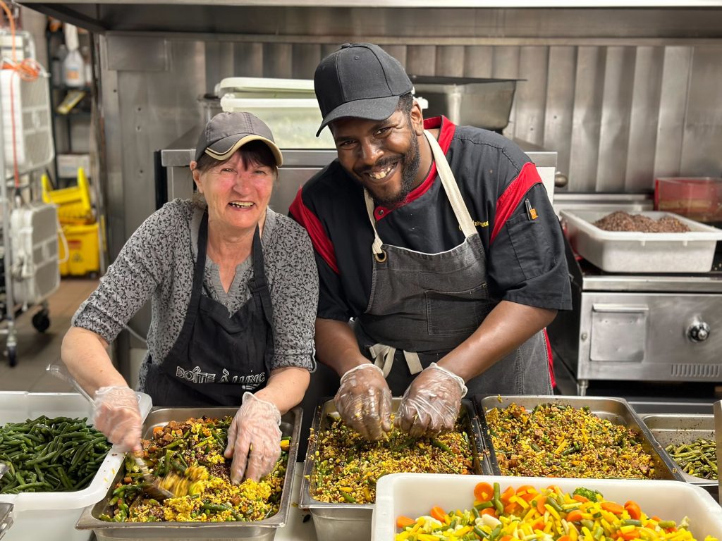 Staff and volunteers preparing food for The Depot's community meal, the Resto Depot.