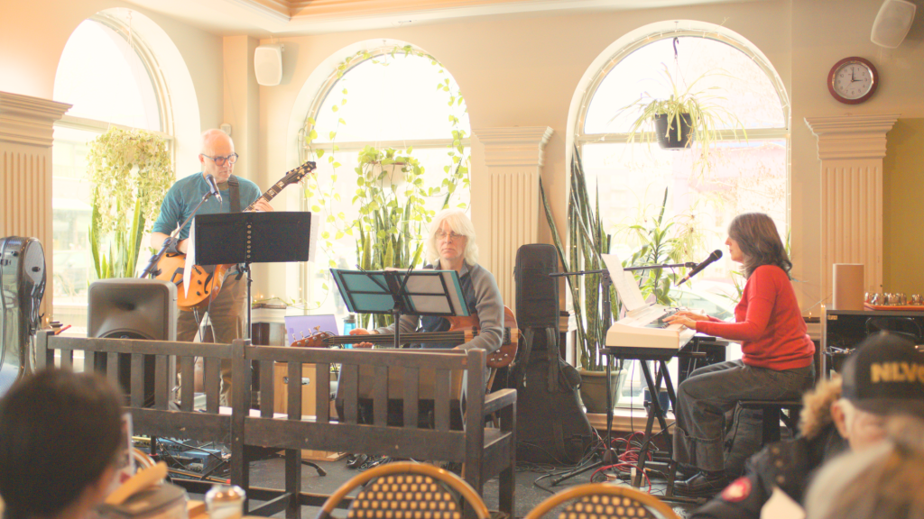 Live music being performed during a community meal at the Resto Depot.
